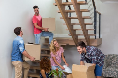 Professional man and van removal company loading household items for a small move
