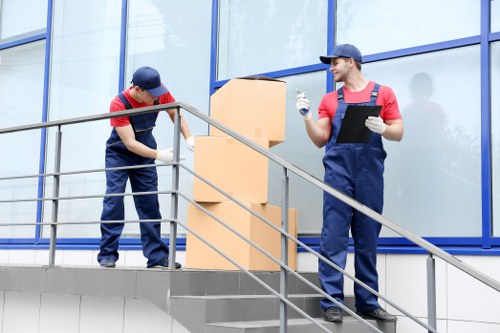 Flexible man with a van removals team handling boxes and equipment
