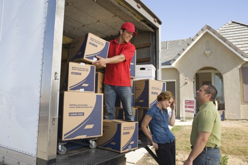Commercial movers transporting office items through a local building