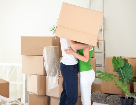 Movers loading boxes and furniture into a removal truck