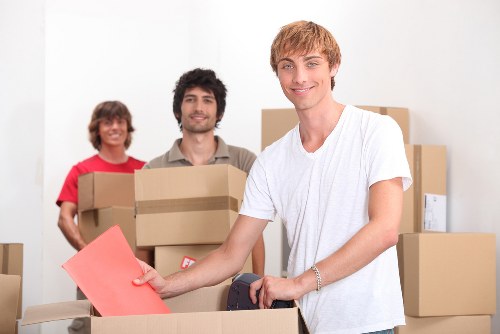 Removal team carrying boxes from a flat during a Removalcompany move